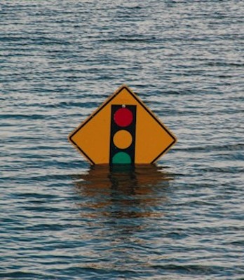 A street sign is under water due to flooding
